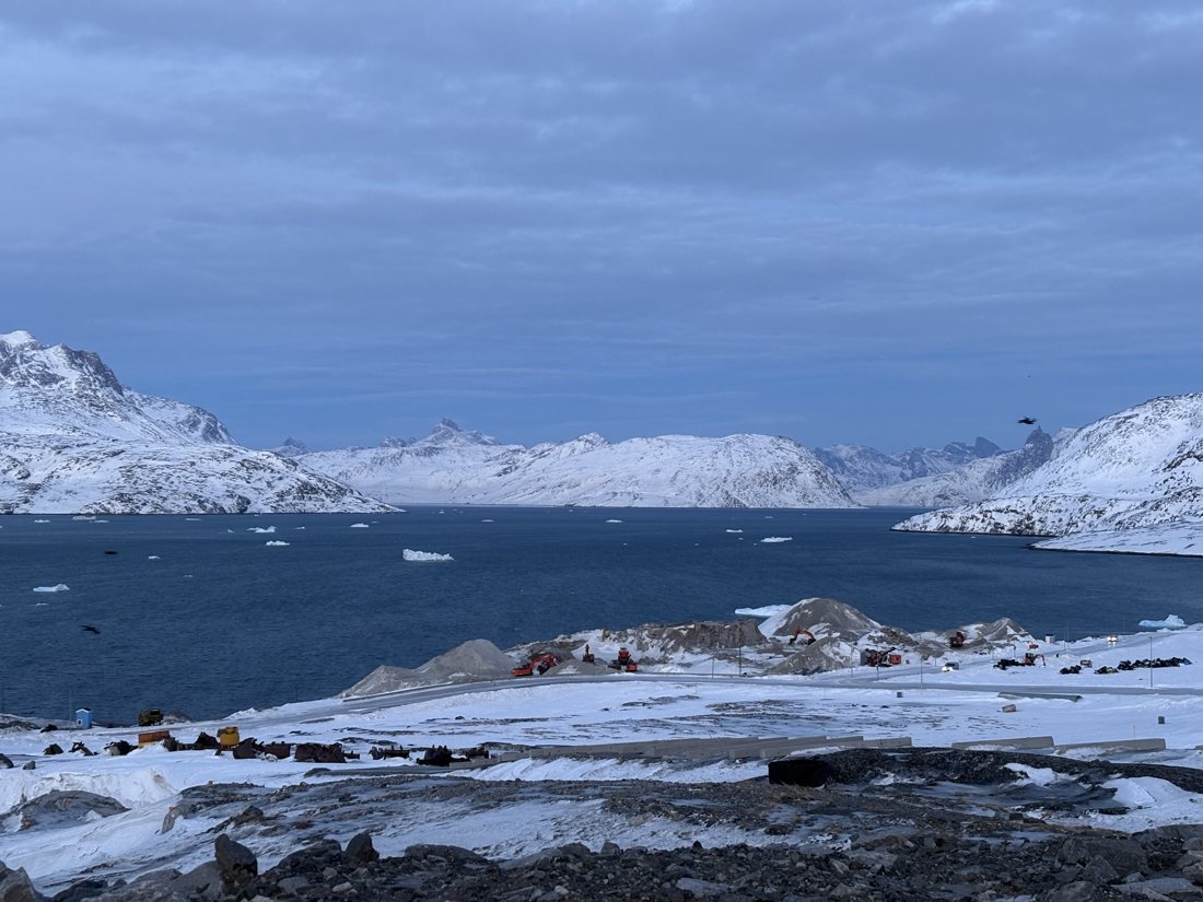Icebergs in a Greenland fjord below snow-covered peaks